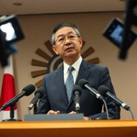 Japan Chief Cabinet Secretary Yoshimasa Kihara speaking at a press conference about monetary policy.