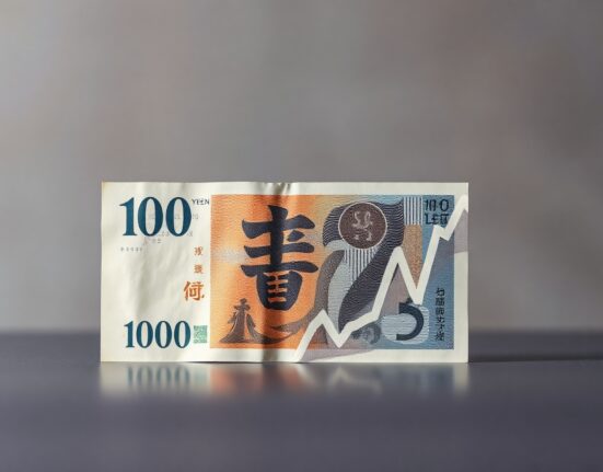 Japanese yen banknote with faint declining chart overlay representing limited currency relief