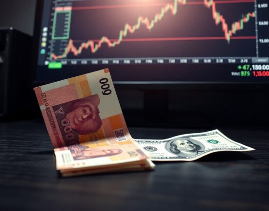 Japanese Yen banknote and US Dollar bill on desk with trading chart showing USD/JPY near 160 level