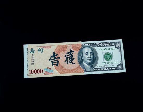 Japanese Yen and US Dollar banknotes on a desk, representing currency exchange rates