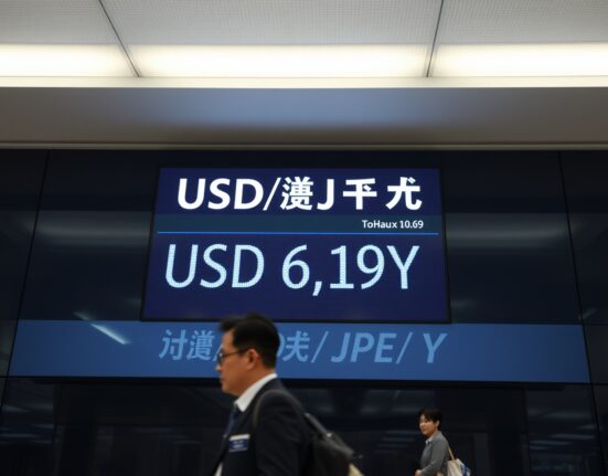 Currency exchange board in Tokyo showing USD/JPY rate at historic low