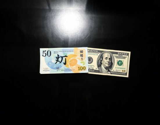 Japanese yen and US dollar banknotes on a dark surface, representing currency exchange and forex market analysis.