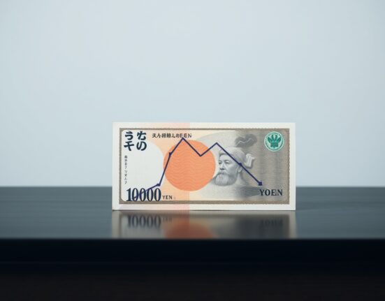 Japanese yen banknote with a downward chart overlay symbolizing currency weakness.