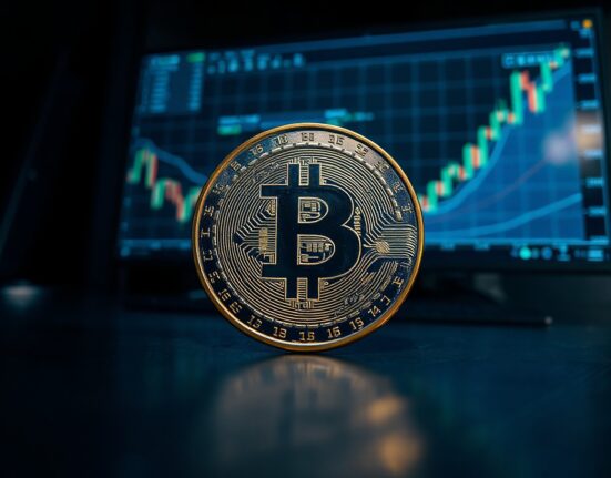 Litecoin (LTC) coin on reflective surface with digital chart in background