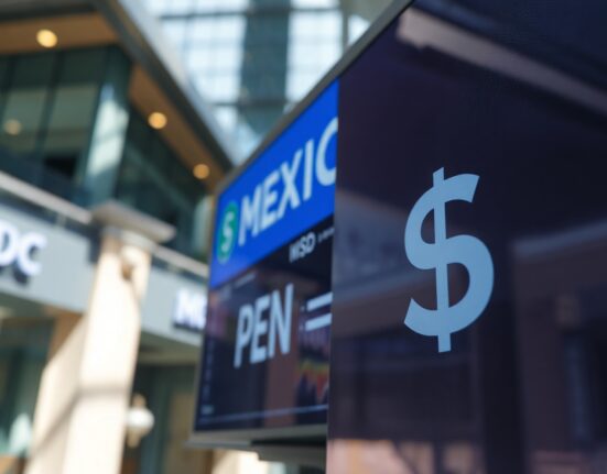 Currency exchange board showing MXN and USD rates in a financial district