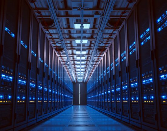 Interior of a modern data center with illuminated server racks and networking equipment