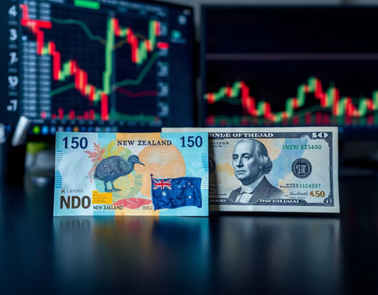 New Zealand Dollar and US Dollar banknotes on a financial desk with charts in background