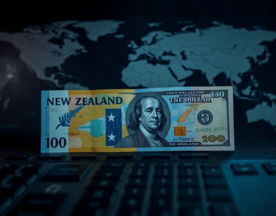 New Zealand Dollar and US Dollar banknotes on a financial desk with a world map background
