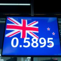 NZD/USD exchange rate display on a trading screen with US and New Zealand flags in background