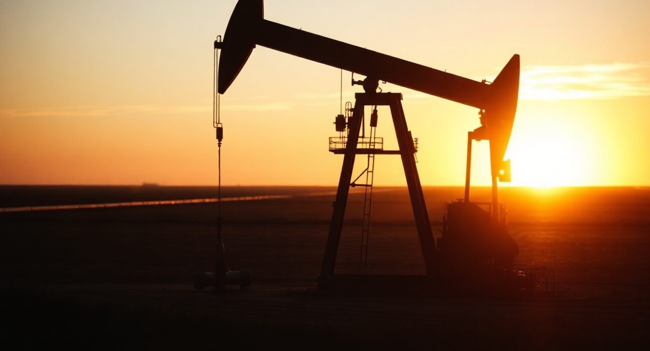 Oil pumpjack silhouetted at sunset in an oil field, representing crude oil supply and demand dynamics.