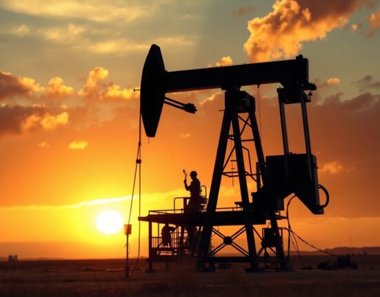 Oil pumpjack silhouetted against smoky sunset sky representing geopolitical tensions and energy market uncertainty.