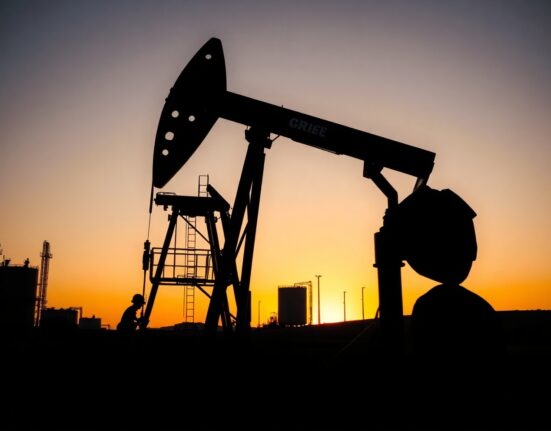 Oil pumpjack silhouetted at sunset, representing energy supply risks and market outlook.