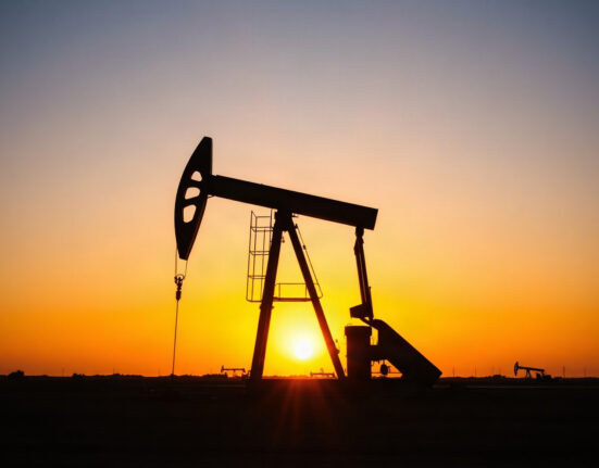 Oil pumpjack silhouetted against a sunset sky, symbolizing crude oil supply and market dynamics.