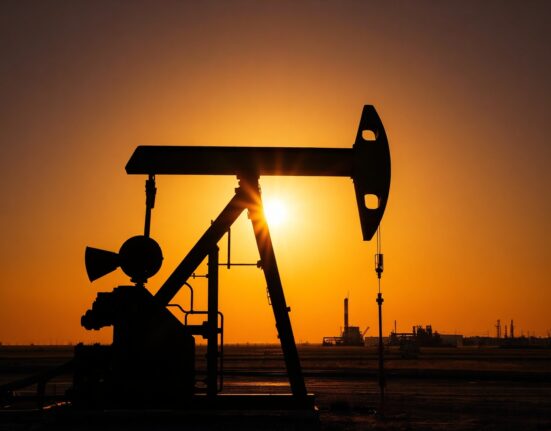 Oil pump jack silhouetted against sunset, representing oil markets amid Middle East tensions