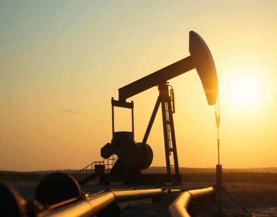 Oil pumpjack silhouette at sunset representing crude market volatility