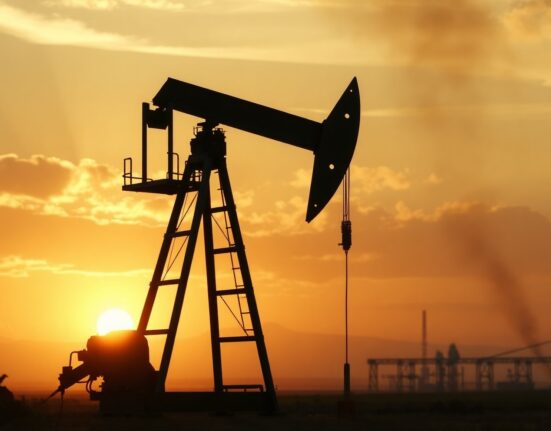 Oil pumpjack silhouette at sunset with smoky horizon symbolizing geopolitical risk