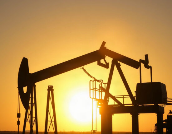Oil pumpjack silhouette at sunset, representing crude oil supply and market movements