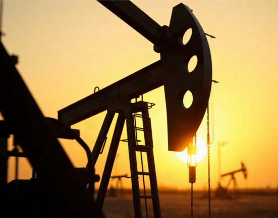 Oil pumpjack silhouetted against a sunset sky, representing oil market volatility