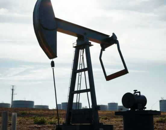 Oil pumpjack in a field, representing crude oil supply and market dynamics.