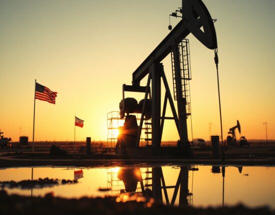 Oil pumpjack at sunset with US and Iranian flag reflections symbolizing geopolitical supply talks