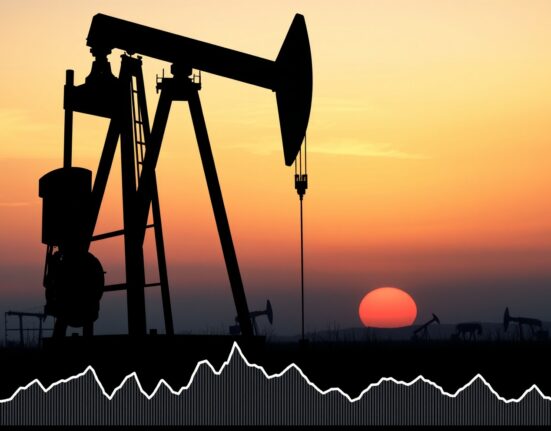 Oil pumpjack silhouette against sunset with downward trending price chart overlay