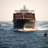 Oil tanker navigating the Strait of Hormuz with geopolitical risk in focus