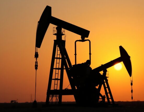 Oil pump jack silhouetted against a sunset sky, symbolizing market uncertainty.
