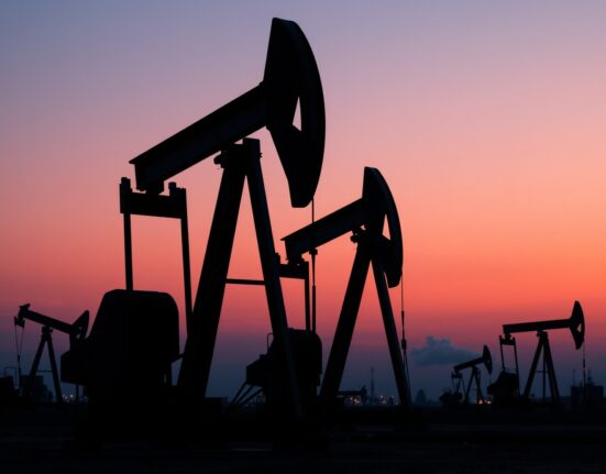 OPEC+ decision to increase oil production during global energy crisis shown through active oil field operations.