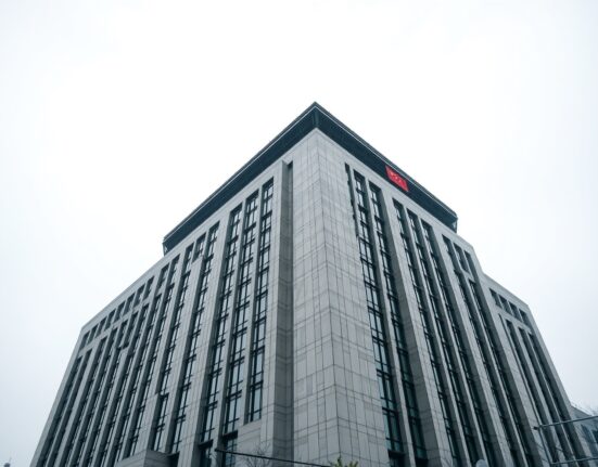 People's Bank of China headquarters in Beijing on a cloudy day, representing China's central bank currency policy.