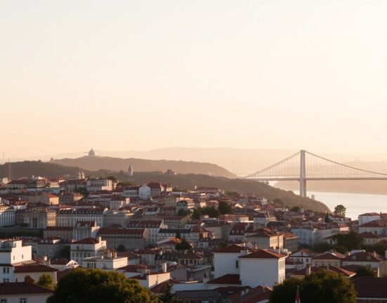 Lisbon skyline at sunrise over the Tagus River, illustrating Portugal's stable business climate in July.