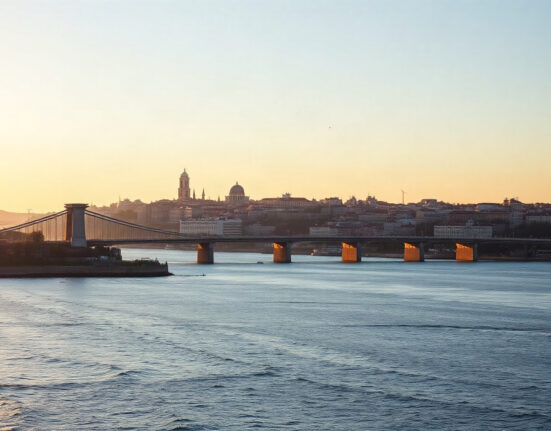 Lisbon skyline and Tagus River at sunset, representing Portugal's economic growth in Q2 2025.