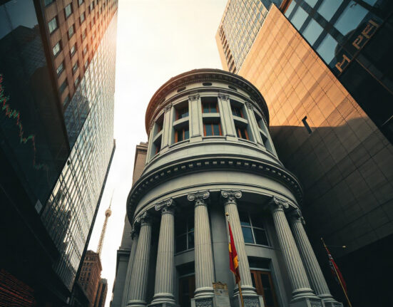 Central bank building with stock market charts reflected in glass, representing upcoming rate decisions and NFP report.