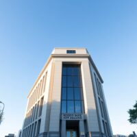 Reserve Bank of New Zealand building in Wellington under a clear sky.