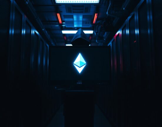 Glowing Monero logo on a monitor in a dark server room, representing the RetoSwap hack.