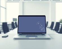 Salesforce Slack AI update featuring the new intelligent Slackbot interface on a laptop in a modern office.