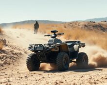 Scout AI autonomous ATV navigating a dusty trail at a military base during AI training for defense applications.