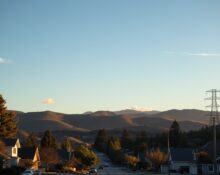 A serene vacation town in the Santa Cruz Mountains with power lines in the background during golden hour.