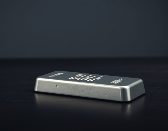Close-up of a polished silver bar on a dark surface with soft lighting, representing precious metals investment and market analysis.