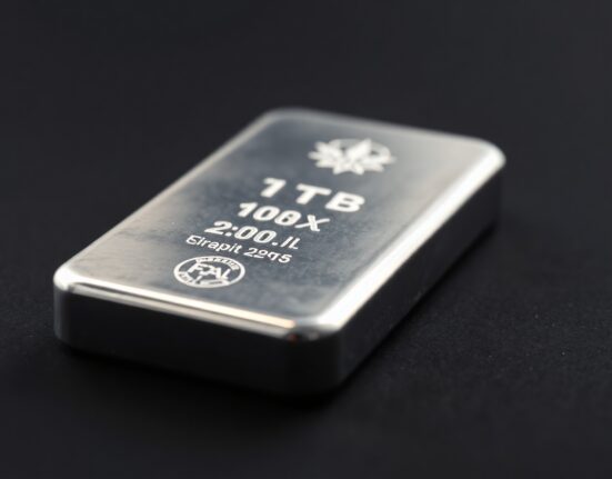 Close-up of a polished silver bar on a dark surface for precious metals market news