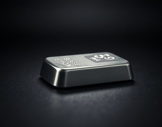 Close-up of a polished silver bar on a dark surface, representing precious metals market trends.