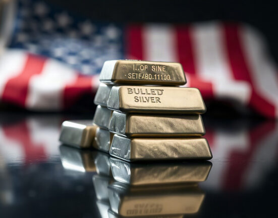 Silver bullion bars stacked on reflective surface with US flag bokeh in background