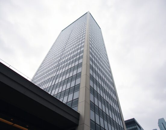 Exterior of a modern office building representing SkyBridge Capital's headquarters, with overcast sky conveying a serious financial news mood.