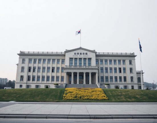 South Korean National Assembly building in Seoul on a cloudy day, representing legislative oversight of cryptocurrency tax policy.