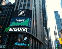 Nasdaq building in Times Square displaying SpaceX stock ticker and green chart on IPO day