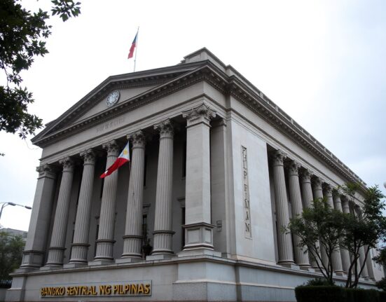 Bangko Sentral ng Pilipinas headquarters in Manila under overcast sky