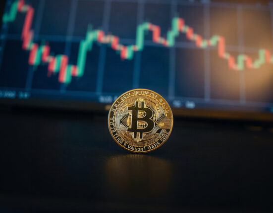 Bitcoin coin on a dark surface with a stock chart in the background, symbolizing market valuation.