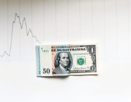 Swiss Franc and US Dollar banknotes on a financial chart background representing stable exchange rate range.