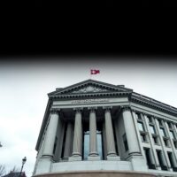 Swiss National Bank building in Bern under overcast sky, representing economic deflationary pressures.