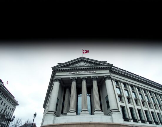 Swiss National Bank building in Bern under overcast sky, representing economic deflationary pressures.