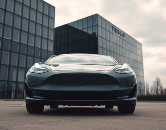 Tesla electric vehicle parked outside corporate headquarters under overcast sky, representing Q2 earnings miss.